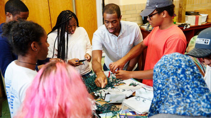 Teaching Fellow and students working on a project at Knowles Teacher Initiative